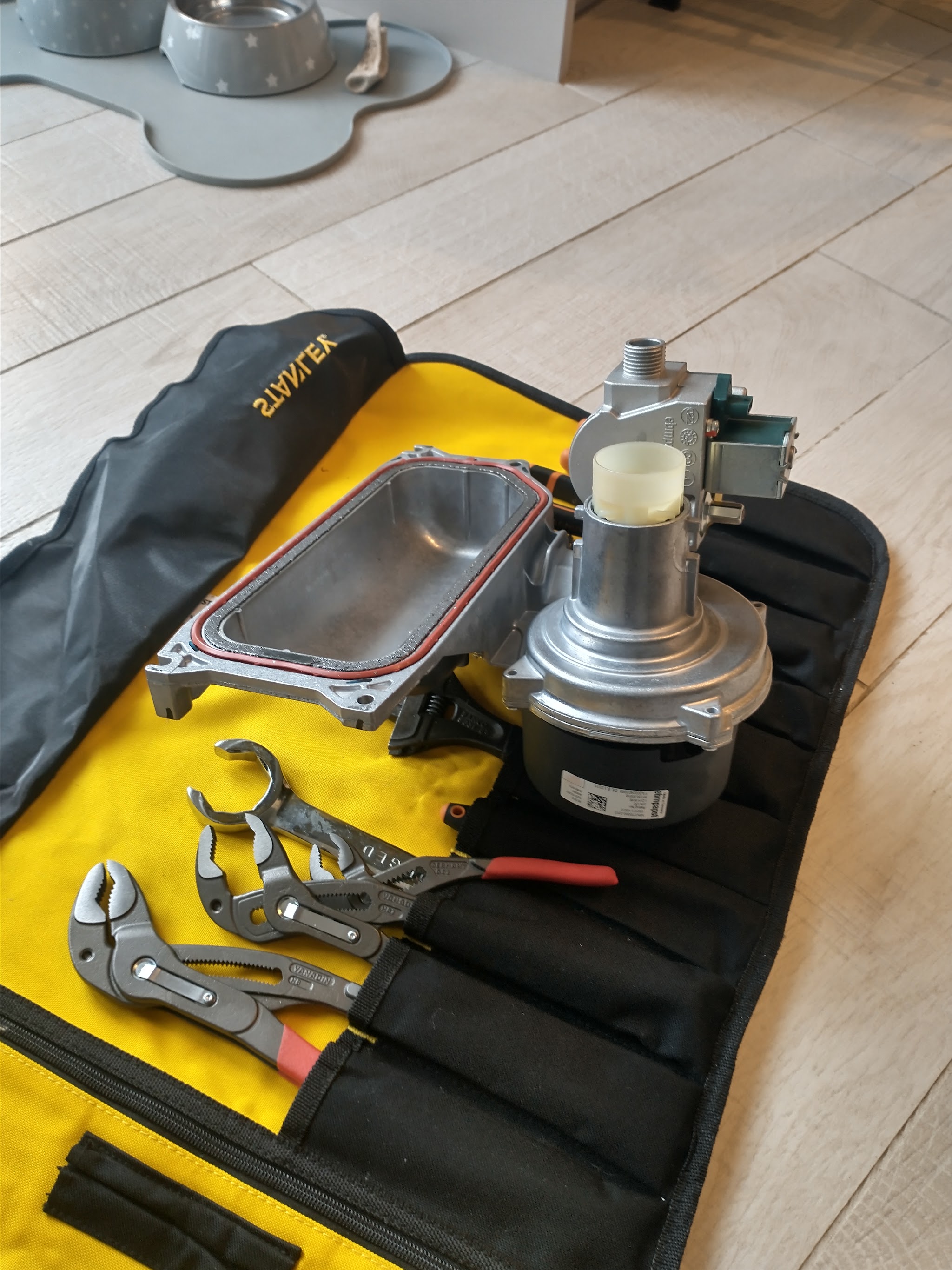 Replacement boiler parts laid out on a tool roll