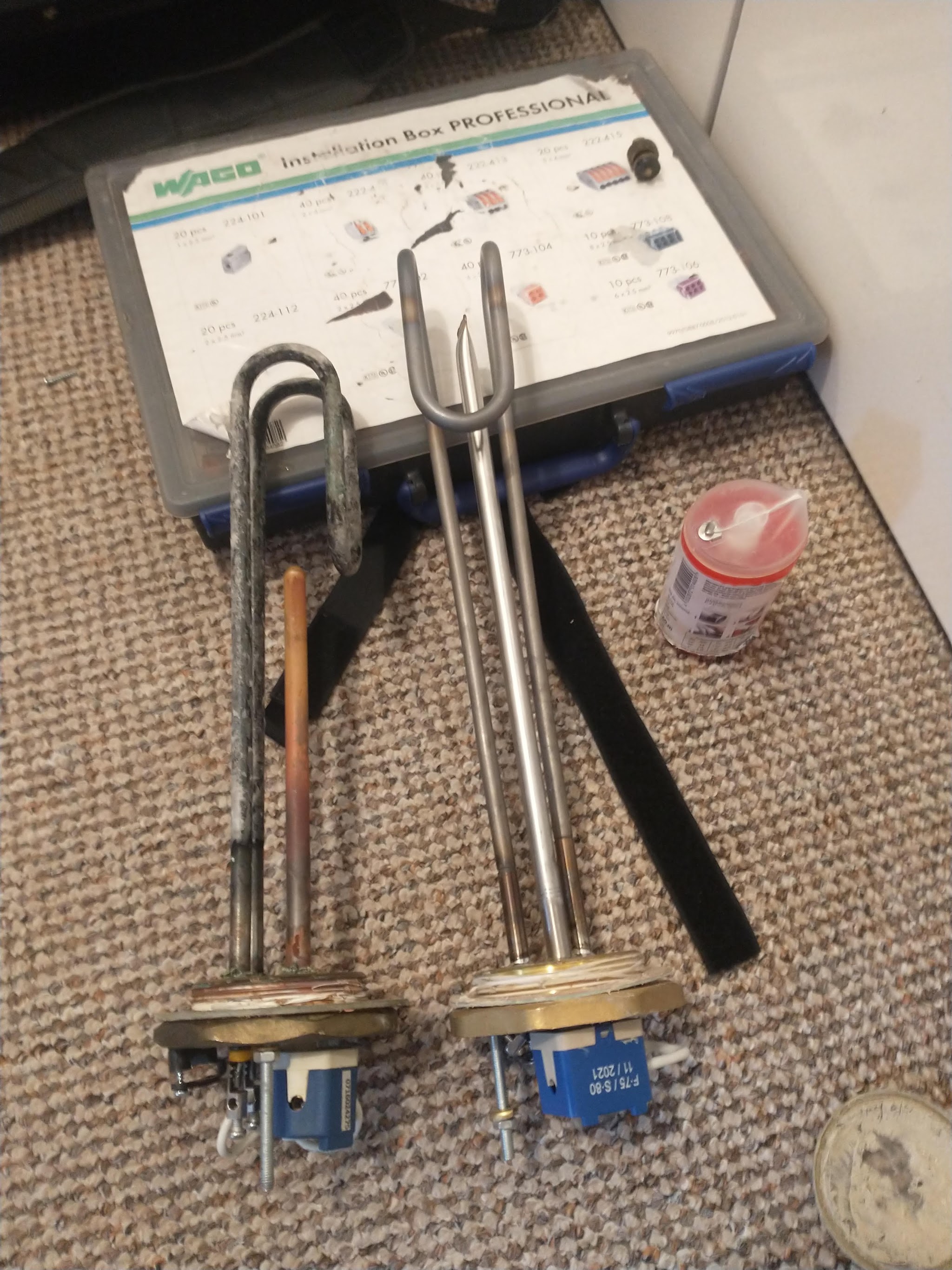 Two worn immersion heater elements taken out of a cylinder
