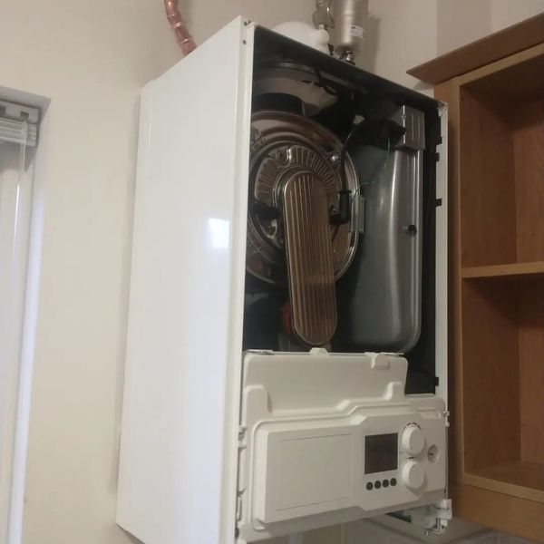 A wall-hung boiler opened up for servicing