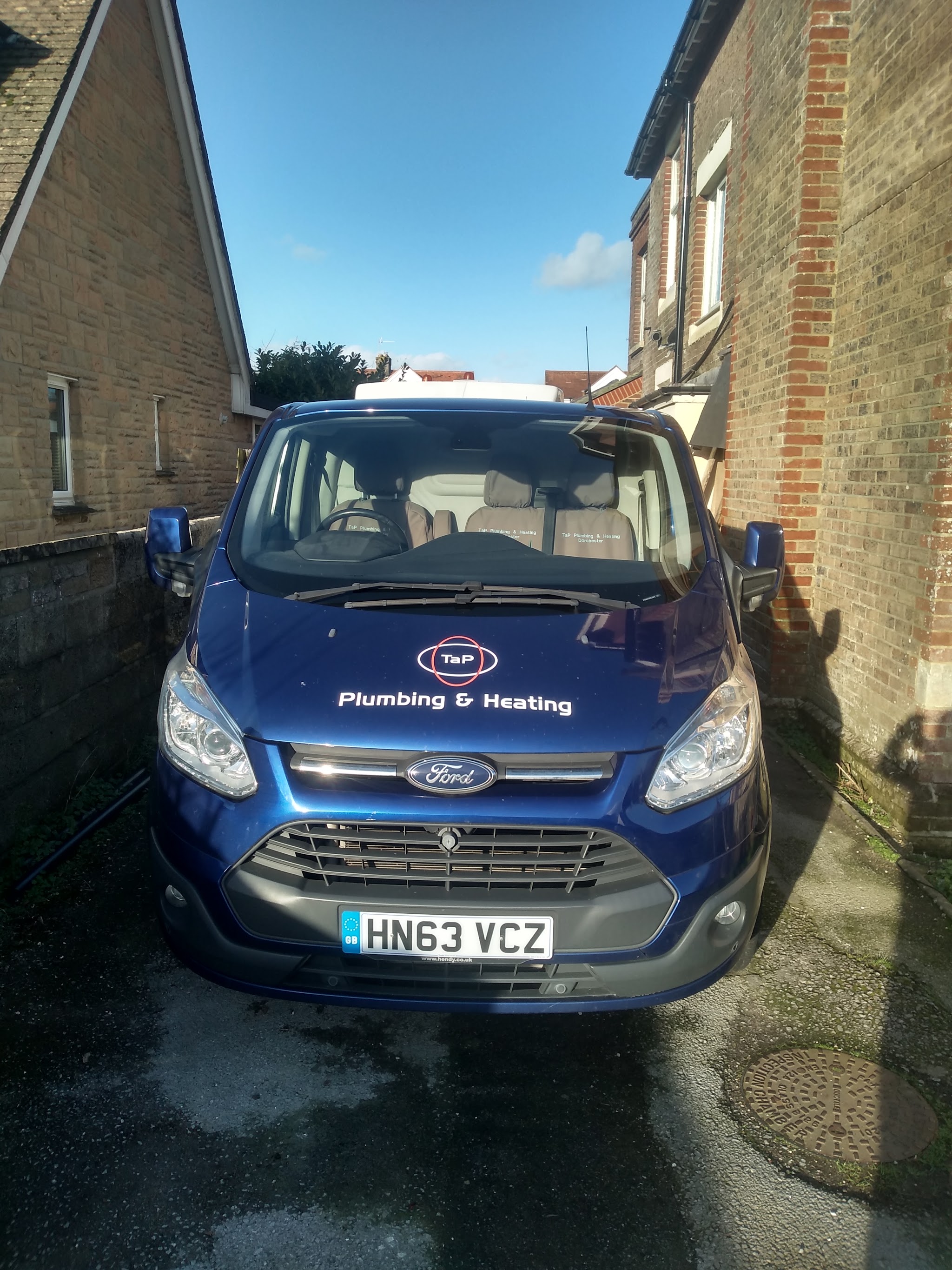 The navy TaP Plumbing & Heating van parked on a Dorchester drive